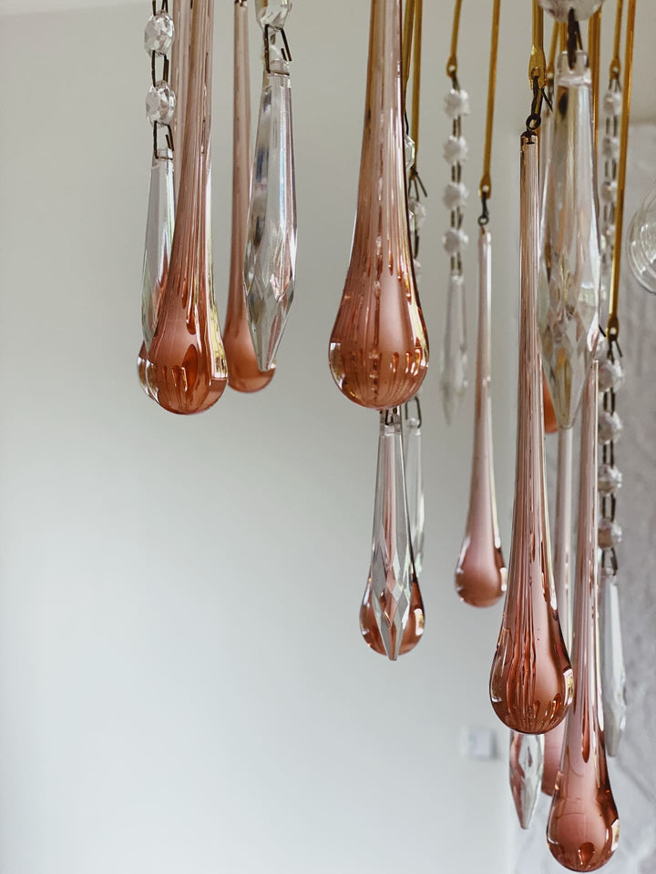 Rose gold teardrop-shaped chandelier against a white background