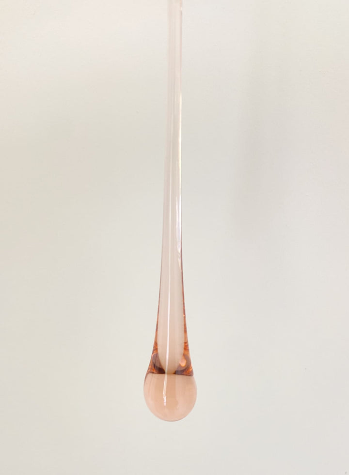 Rose gold pendant on a white background