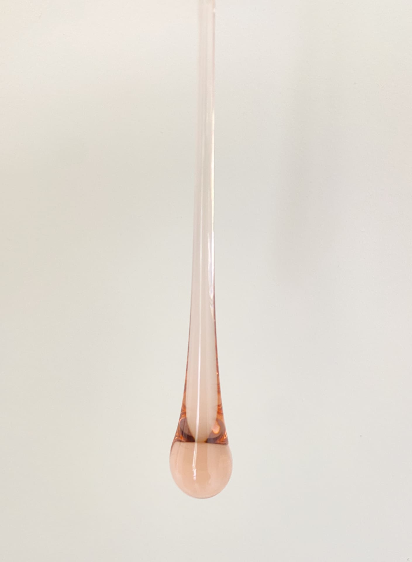 Rose gold pendant on a white background