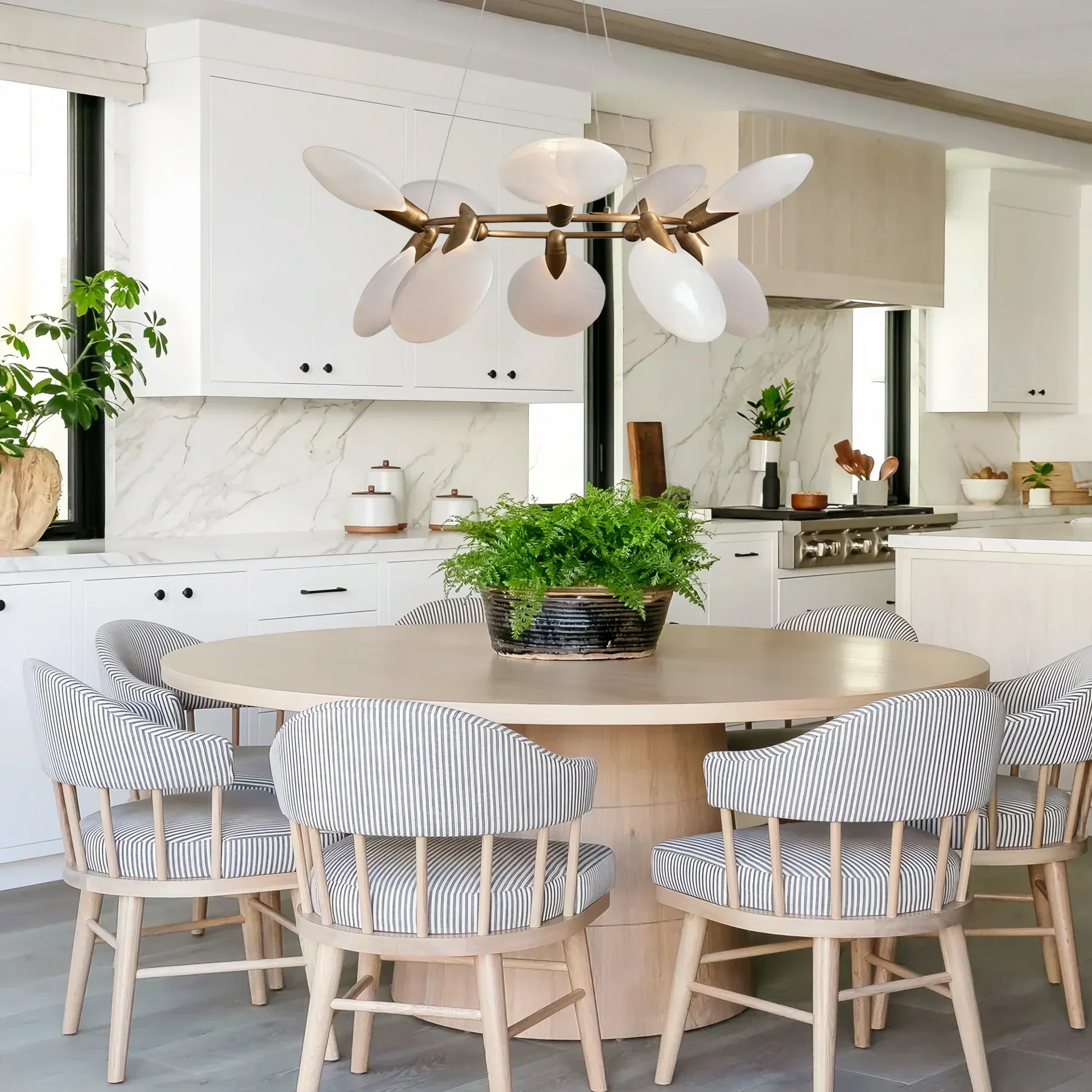Dining room illuminated by Lyla Halo Chandelier with elegant circular design