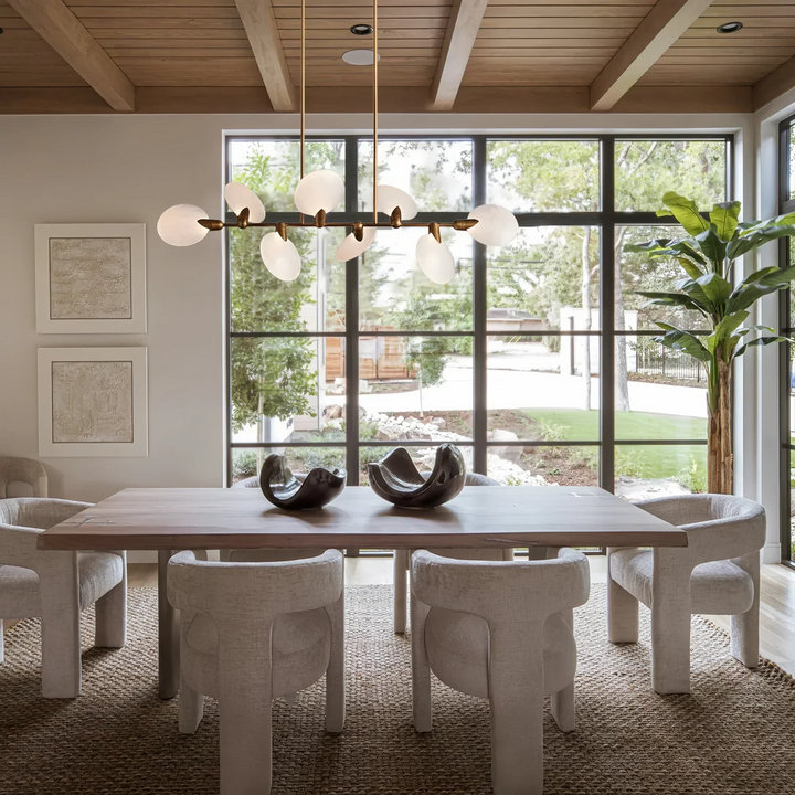 Lyla Linear Chandelier 74 inch modern linear chandelier hanging above dining table